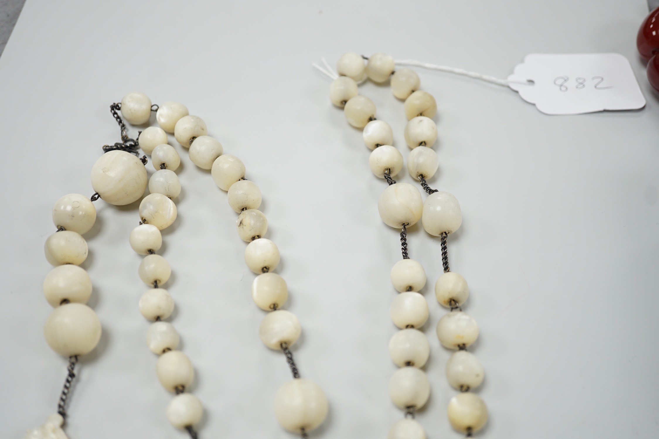 A long mother of pearl rosary, 158cm, with carved mother of pearl crucifix pendant, 8cm.
